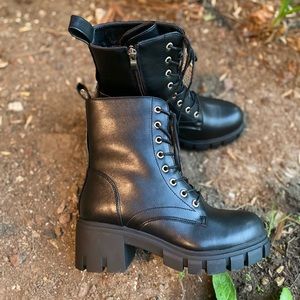 Women Combat Black faux leather boots.